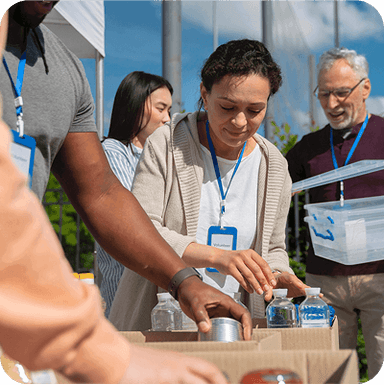TNCSA logo over an image of people filling bags with goods